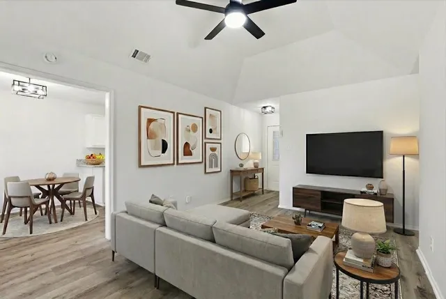 a living room with furniture and a flat screen tv