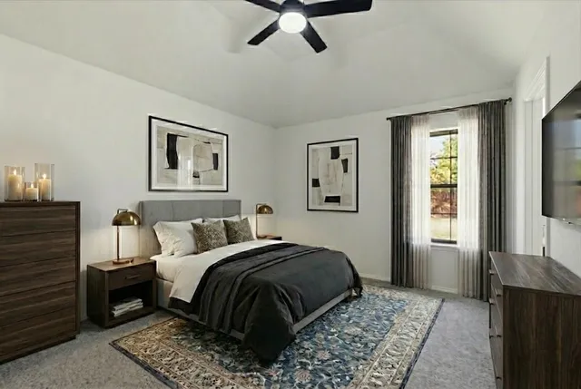 a bedroom with a large bed and a chandelier