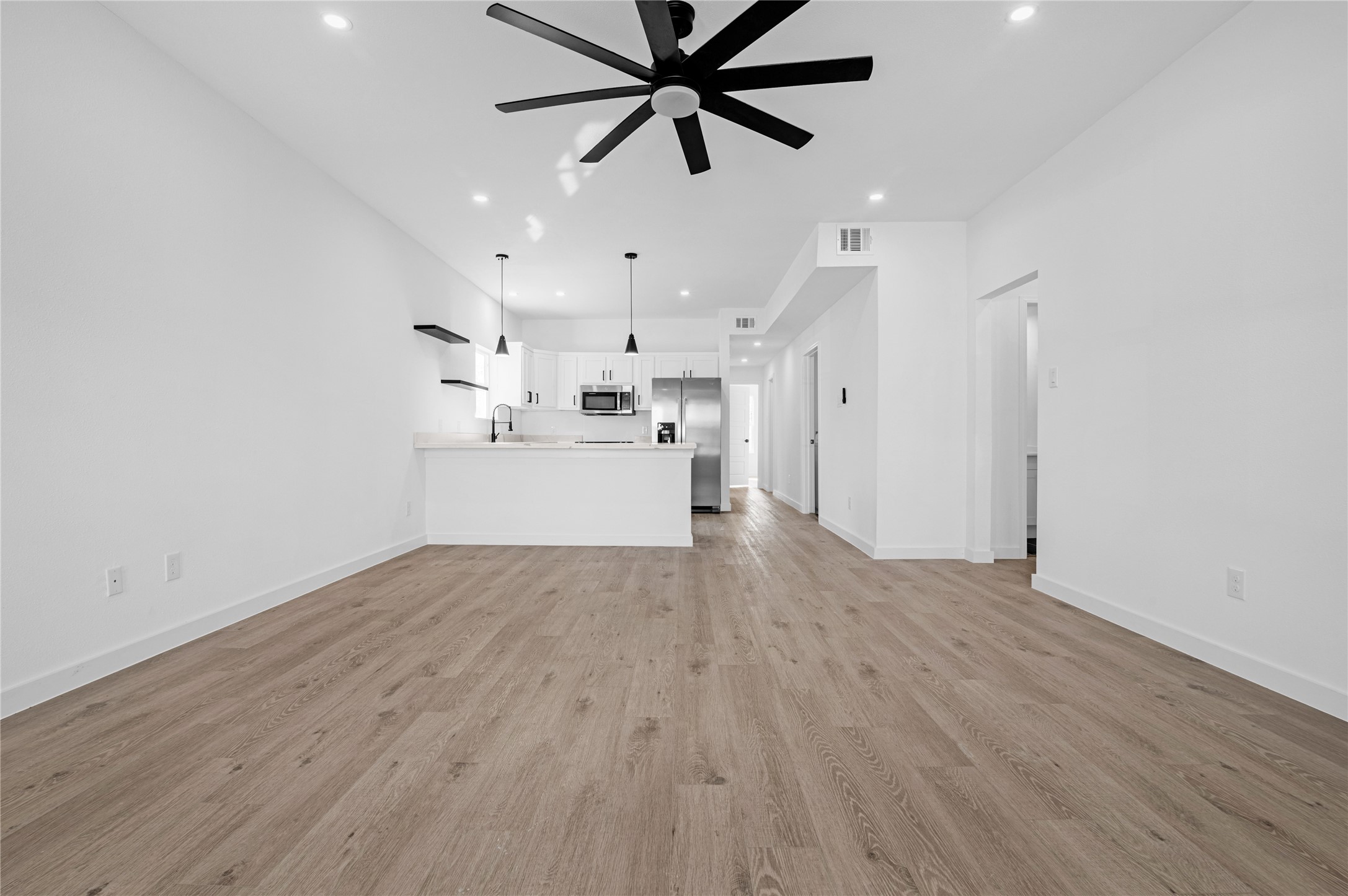 9708 Stedman Street, Unit A Houston, TX 77029 - Photo 4 of 18 Luxury open-concept living with a sleek, modern kitchen designed for effortless flow, style, and everyday comfort.