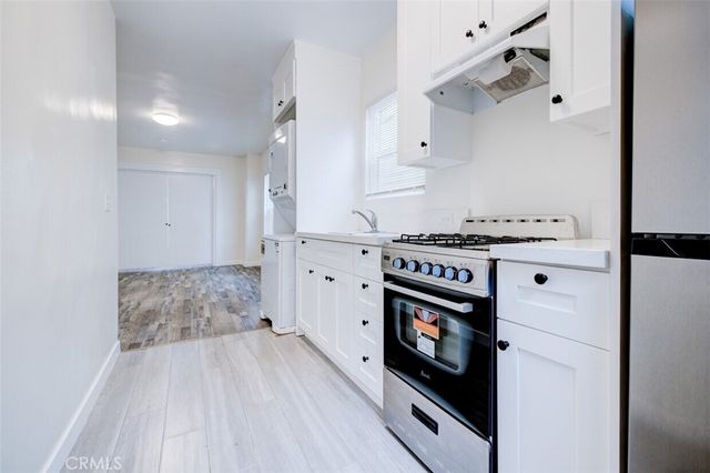 a white toilet sitting next to a bath tub