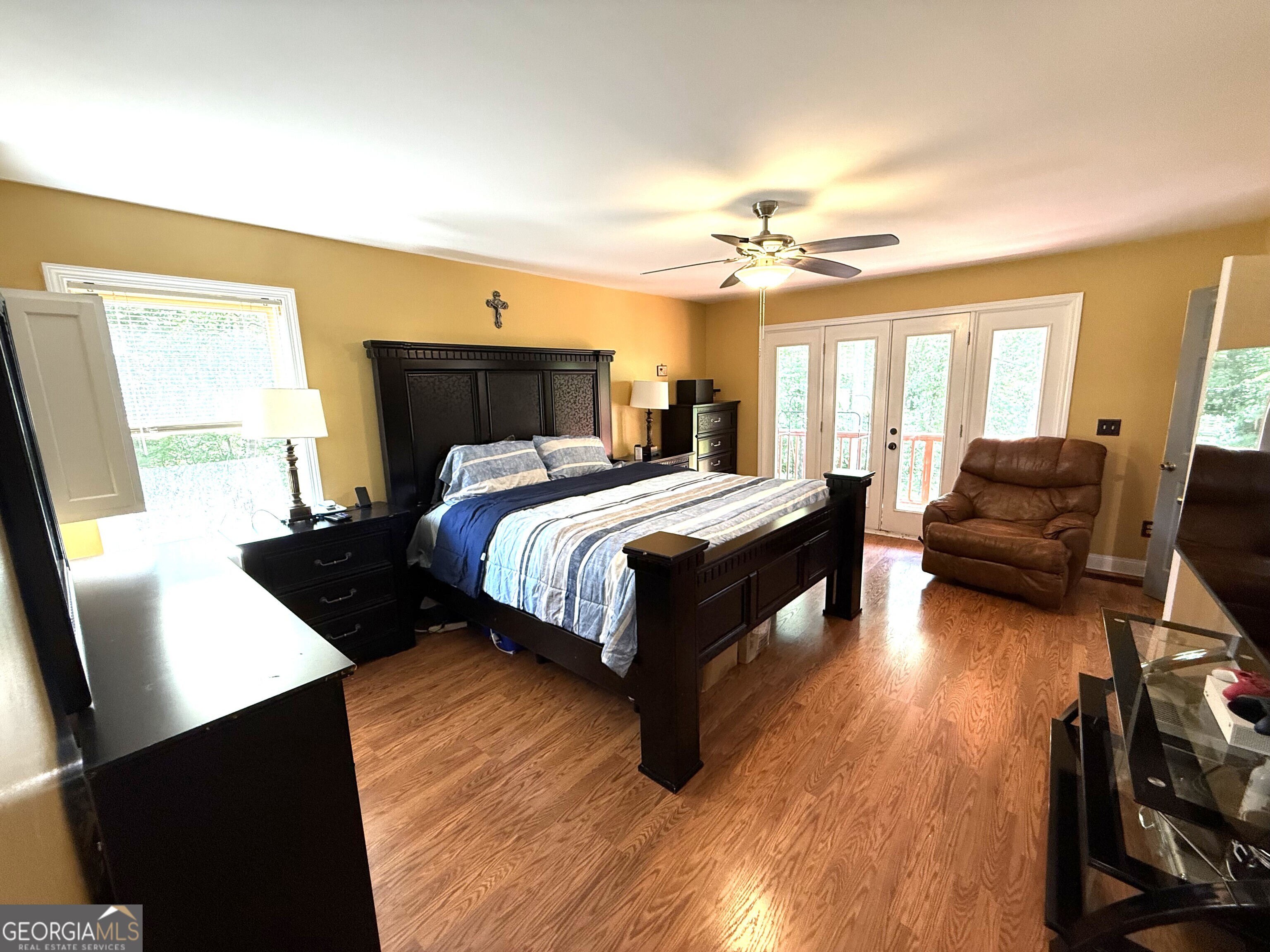 725 Musgrove Road Griffin, GA 30223 - Photo 23 of 52 a bedroom with a bed couches and a flat tv screen on the dresser