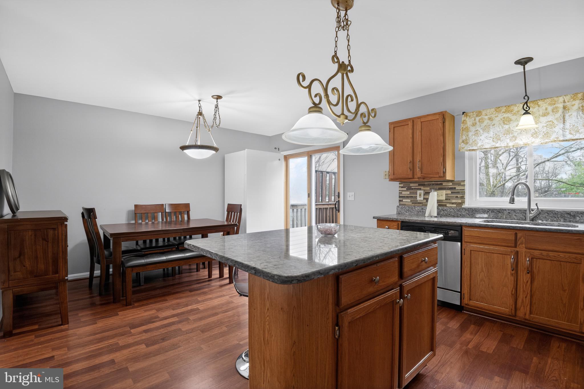 226 Finch Way Newark, DE 19702 - Photo 8 of 30 a kitchen with a counter space a sink appliances and wooden floor