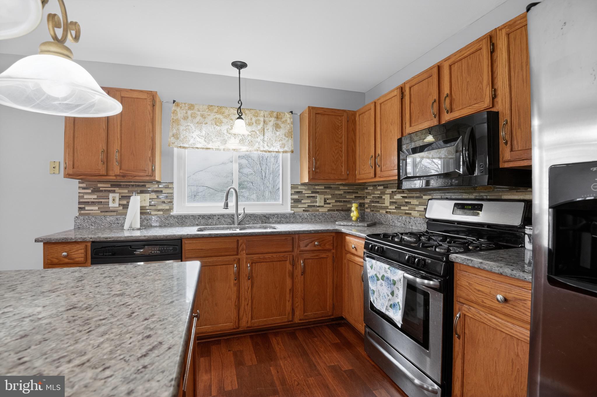 226 Finch Way Newark, DE 19702 - Photo 9 of 30 a kitchen with stainless steel appliances a stove sink microwave and cabinets