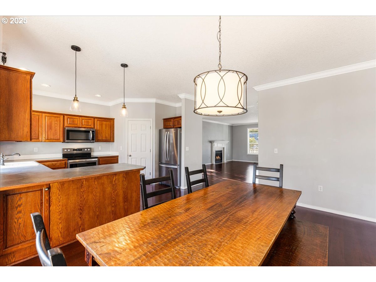 1807 North 8th Way Ridgefield, WA 98642 - Photo 12 of 44 a kitchen with stainless steel appliances kitchen island a chandelier