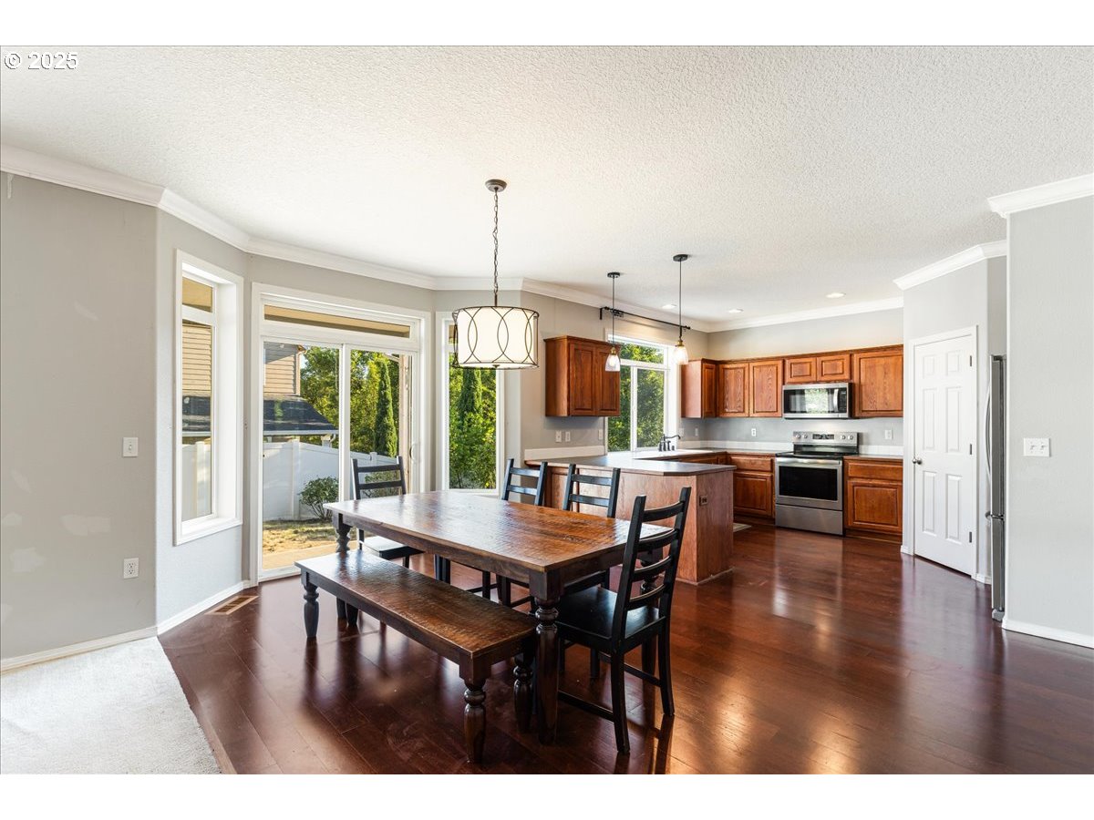 1807 North 8th Way Ridgefield, WA 98642 - Photo 13 of 44 a dining room with furniture window and wooden floor