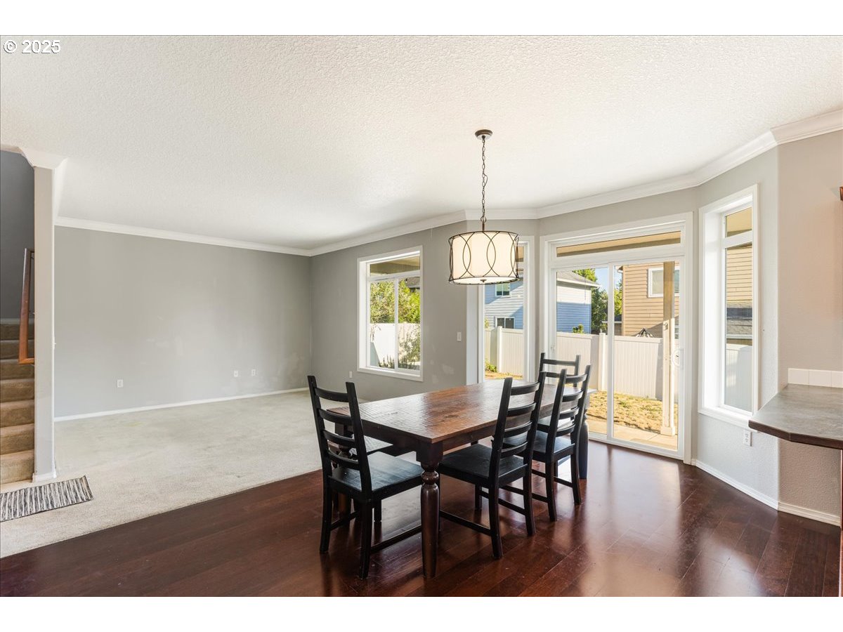 1807 North 8th Way Ridgefield, WA 98642 - Photo 15 of 44 a view of a dining room with furniture window and wooden floor