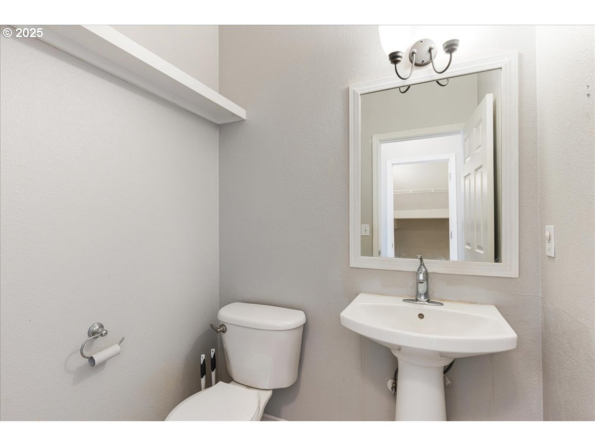 1807 North 8th Way Ridgefield, WA 98642 - Photo 17 of 44 a bathroom with a sink toilet and mirror
