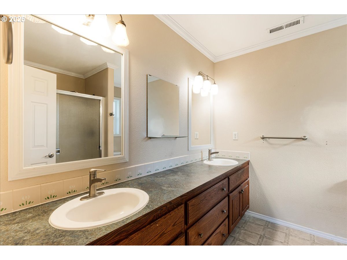 1807 North 8th Way Ridgefield, WA 98642 - Photo 22 of 44 a bathroom with a sink and a mirror