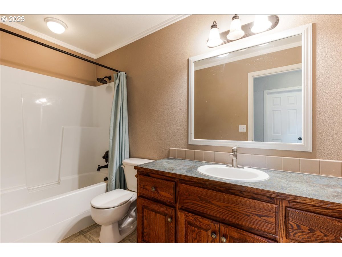 1807 North 8th Way Ridgefield, WA 98642 - Photo 27 of 44 a bathroom with a sink a toilet and shower
