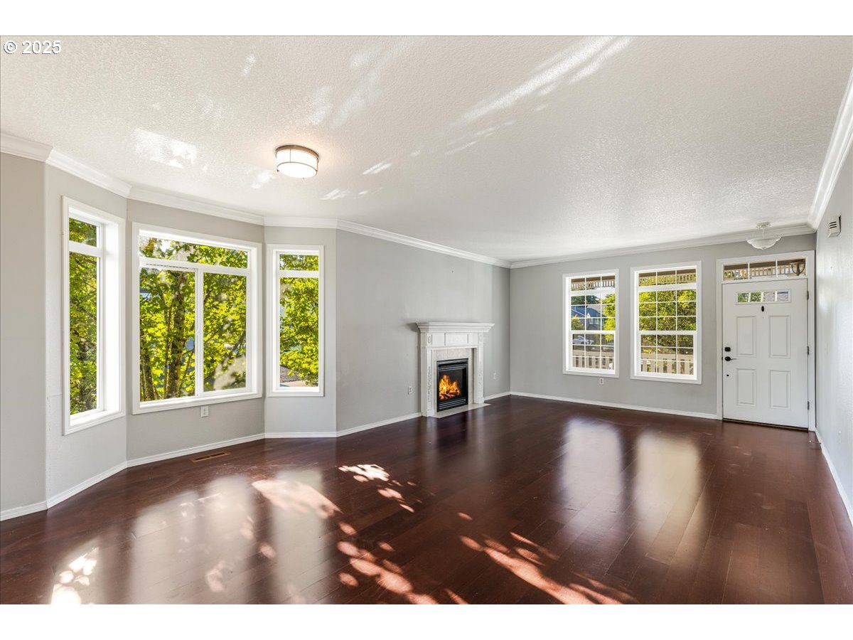 1807 North 8th Way Ridgefield, WA 98642 - Photo 5 of 44 an empty room with wooden floor and windows