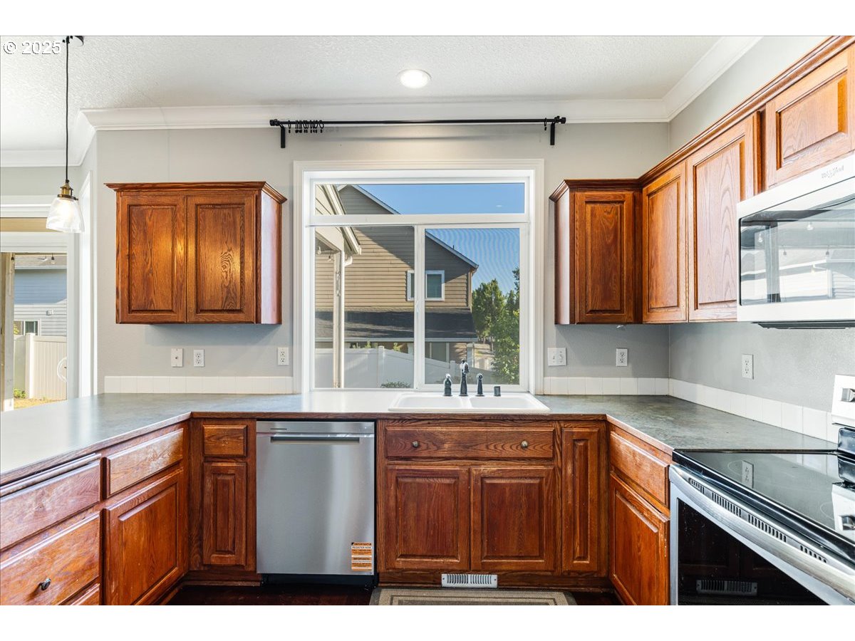 1807 North 8th Way Ridgefield, WA 98642 - Photo 9 of 44 a kitchen with a sink cabinets and window