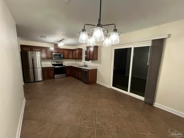a kitchen with refrigerator and cabinets