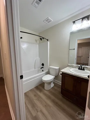 a bathroom with a sink toilet a mirror and shower
