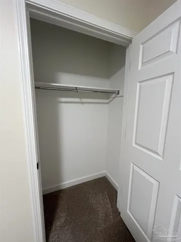 a view of an empty room with a closet