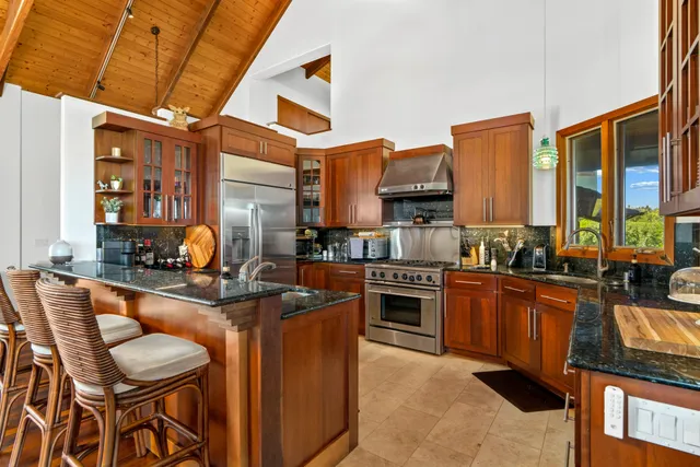 a kitchen with stainless steel appliances granite countertop a stove and a sink