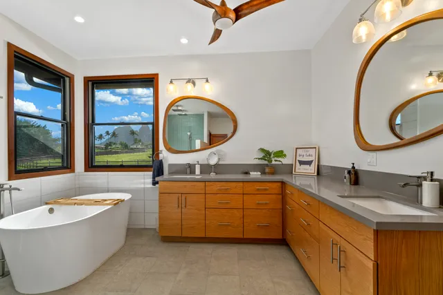 a bathroom with a tub sink and mirror