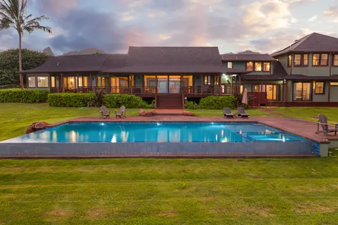 a view of a house with a big yard and a garden