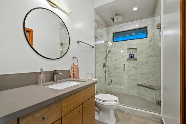 a living room with furniture a wooden floor and next to a window