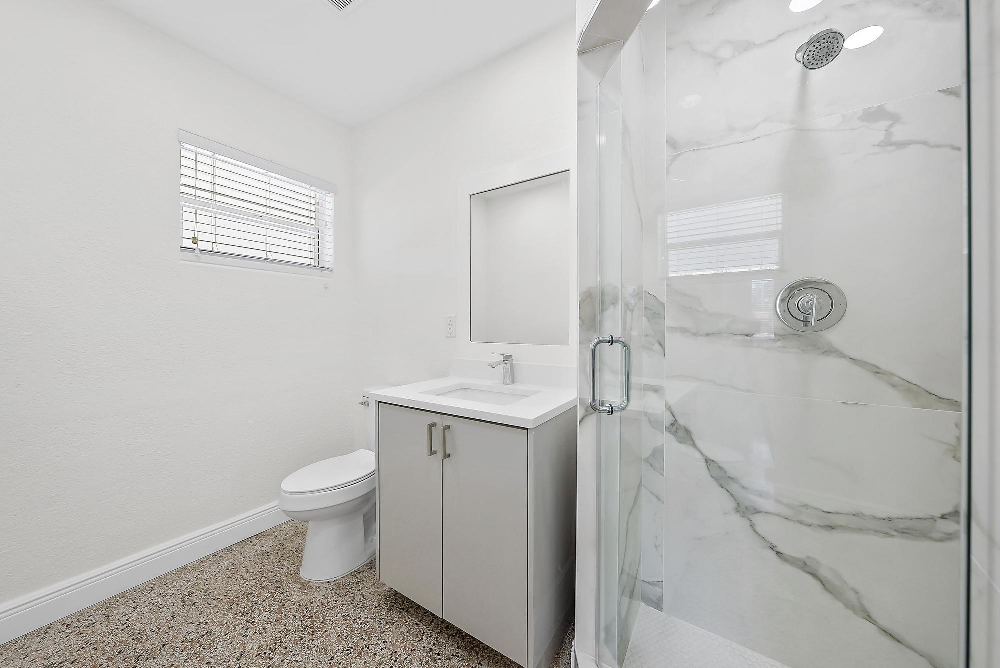 3808 Broadway Avenue West Palm Beach, FL 33407 - Photo 11 of 34 a bathroom with a sink toilet and shower