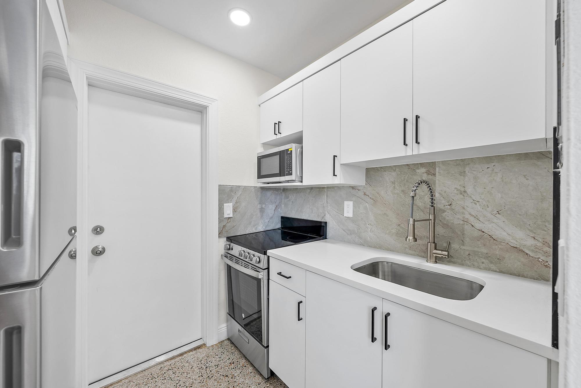 3808 Broadway Avenue West Palm Beach, FL 33407 - Photo 19 of 34 a kitchen with a sink cabinets and appliances