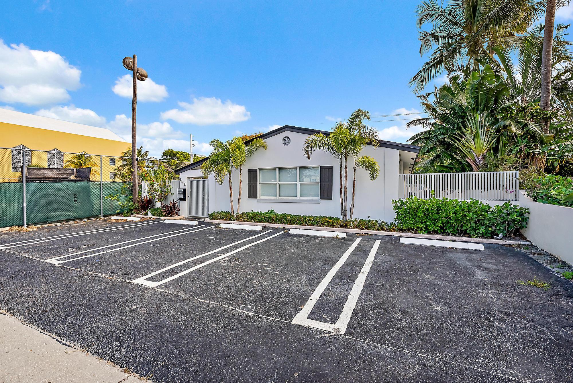 3808 Broadway Avenue West Palm Beach, FL 33407 - Photo 26 of 34 a front view of a house with a yard and garage