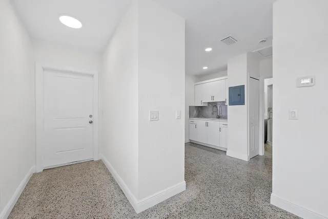 a kitchen with stainless steel appliances a stove a sink and a refrigerator