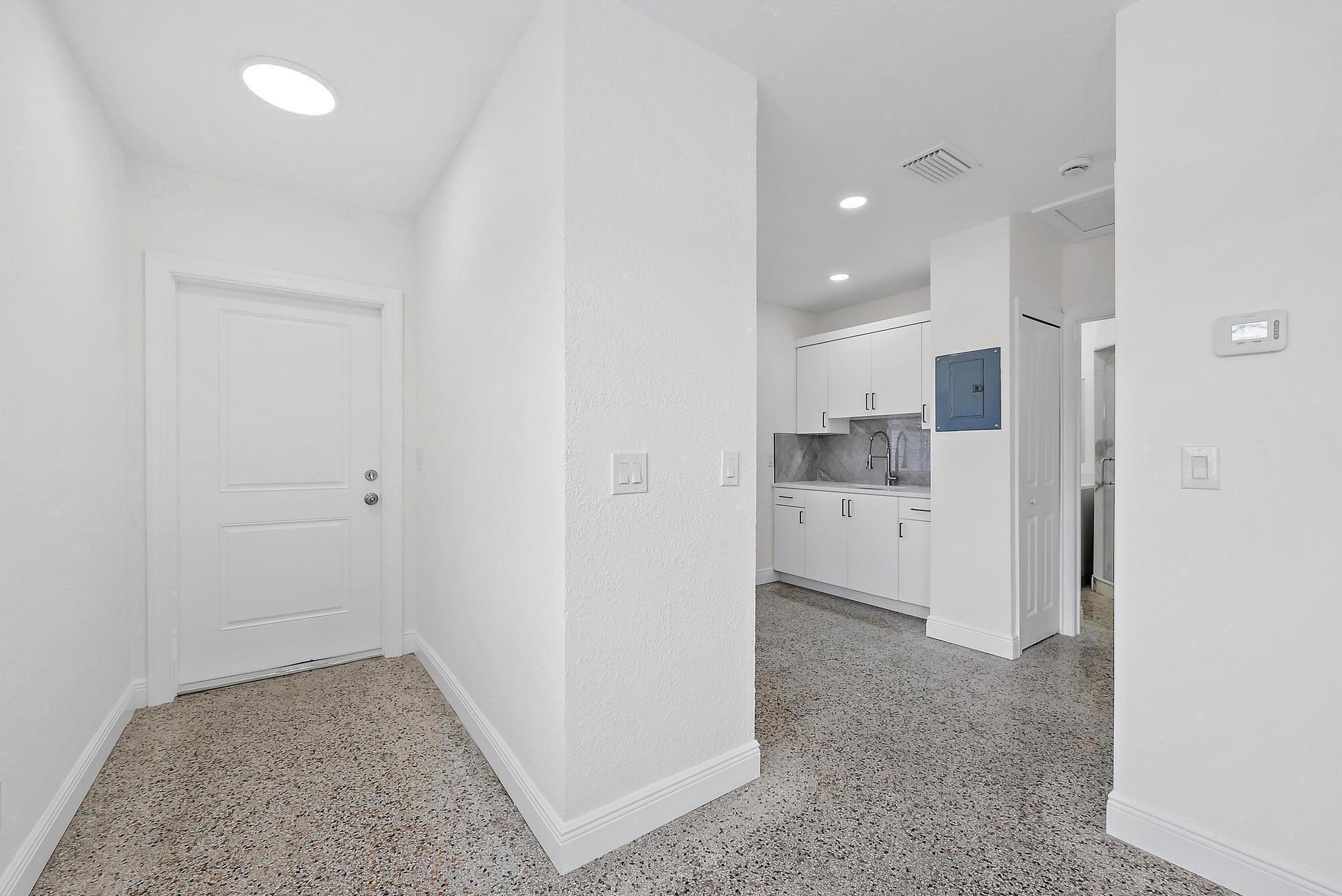 3808 Broadway Avenue West Palm Beach, FL 33407 - Photo 7 of 34 a view of a kitchen with a sink and a refrigerator