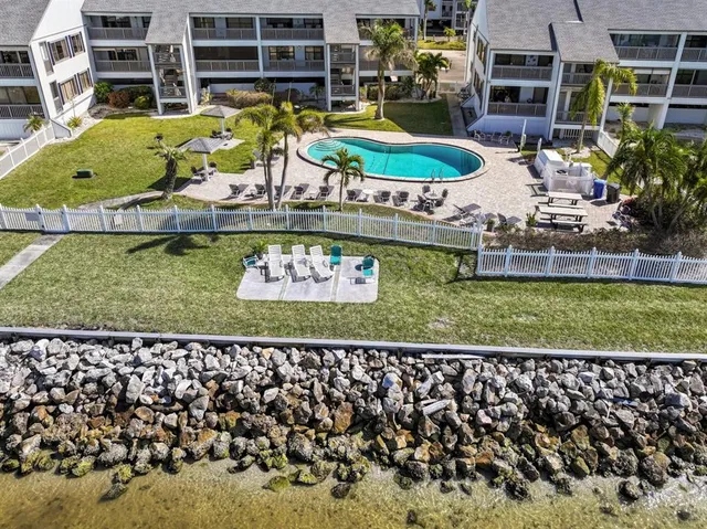 an aerial view of a house with a garden and swimming pool