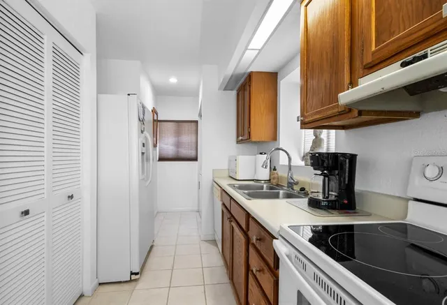 a kitchen with a sink cabinets and a window