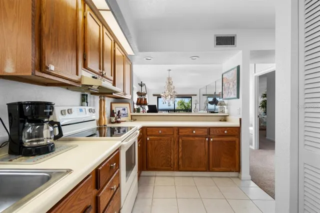 a kitchen with a sink dishwasher stove and cabinets