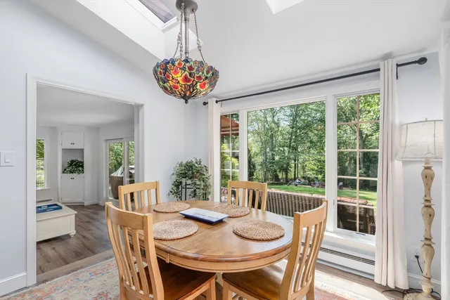 a view of a dining room with furniture wooden floor and chandelier