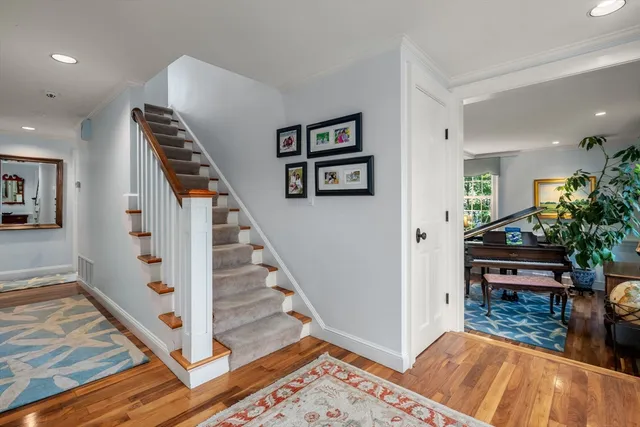 a view of entryway and hall with wooden floor