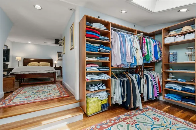 a view of walk in closet with clothes and shoes