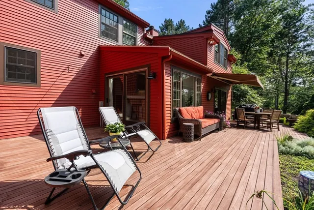 a view of a patio with table and chairs and wooden floor