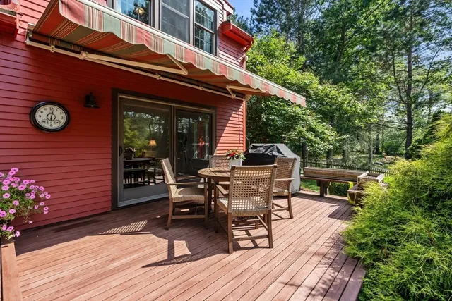a view of a dinning tables and chairs in the patio in front of a house