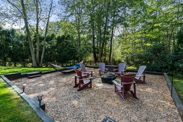 a view of a sitting area with trees in the background