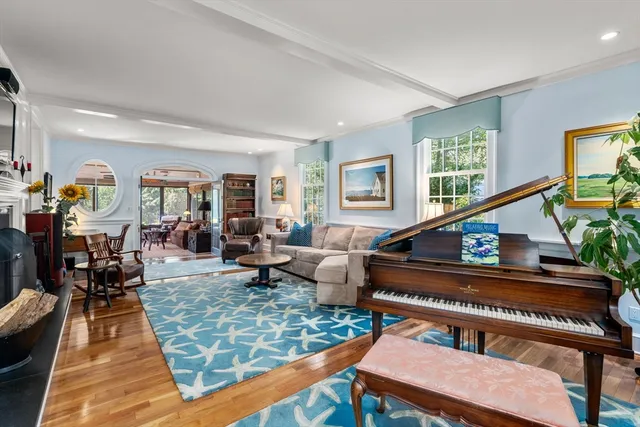 a living room with furniture and a piano