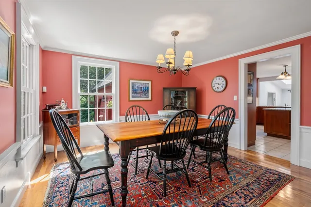 a view of a dining room with furniture wooden floor and chandelier
