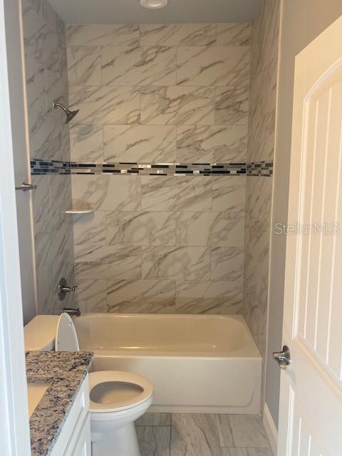 8 Llosee Court, Unit A Palm Coast, FL 32164 - Photo 12 of 21 a bathroom with a granite countertop sink toilet and shower