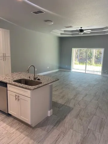 a kitchen with a sink cabinets and window