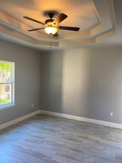 8 Llosee Court, Unit A Palm Coast, FL 32164 - Photo 7 of 21 a view of an empty room with wooden floor and a window