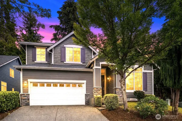 a front view of a house with a yard garage and outdoor seating