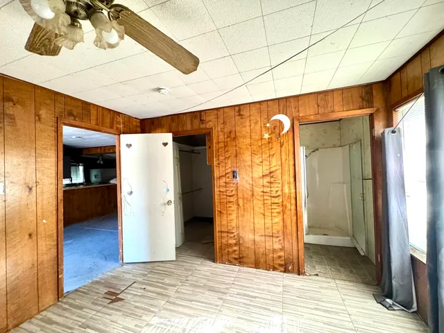 a view of an empty room with windows and closet area