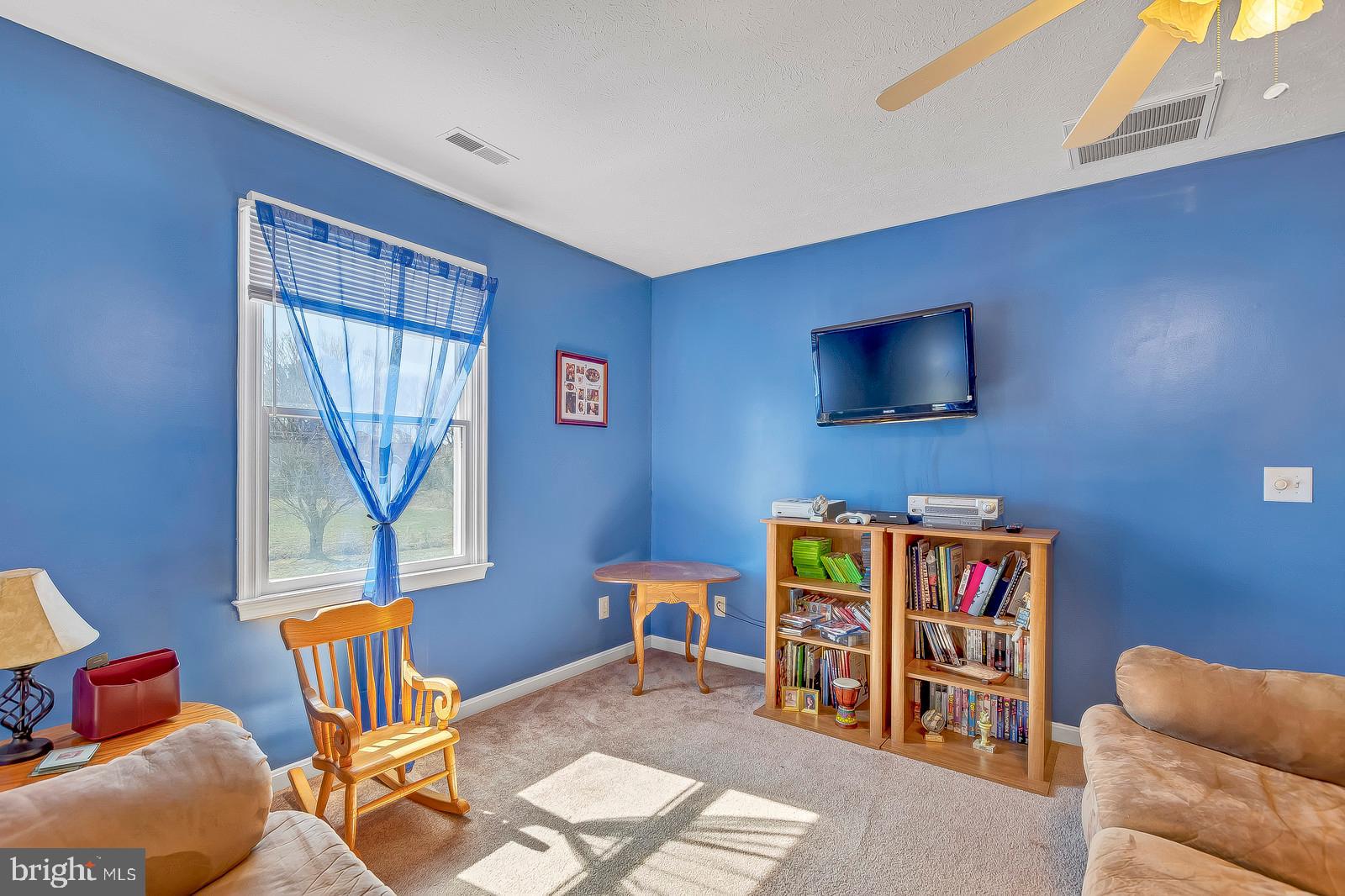 48948 Packer Court St. Inigoes, MD 20684 - Photo 33 of 45 a living room with furniture and a flat screen tv