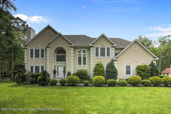 58 Fort Plains Road Howell, NJ 07731 - Photo 1 of 33 a front view of a house with a garden