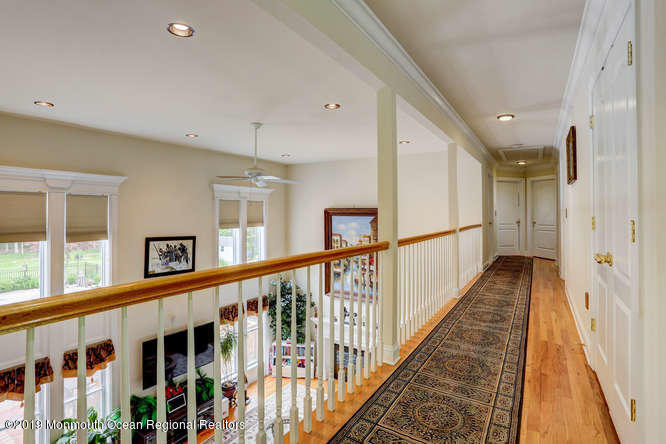 58 Fort Plains Road Howell, NJ 07731 - Photo 14 of 33 a view of a hallway with wooden floor and staircase
