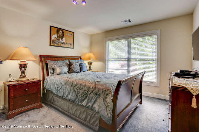 58 Fort Plains Road Howell, NJ 07731 - Photo 19 of 33 a bedroom with a bed and a lamp on dresser next to a window