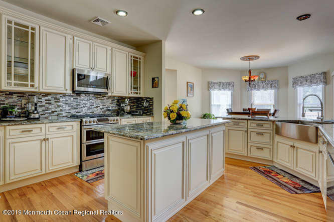 58 Fort Plains Road Howell, NJ 07731 - Photo 3 of 33 a kitchen with granite countertop white cabinets and white appliances