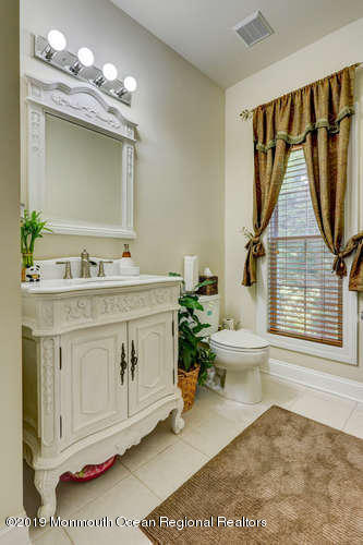 58 Fort Plains Road Howell, NJ 07731 - Photo 24 of 33 a bathroom with a sink a toilet and a mirror