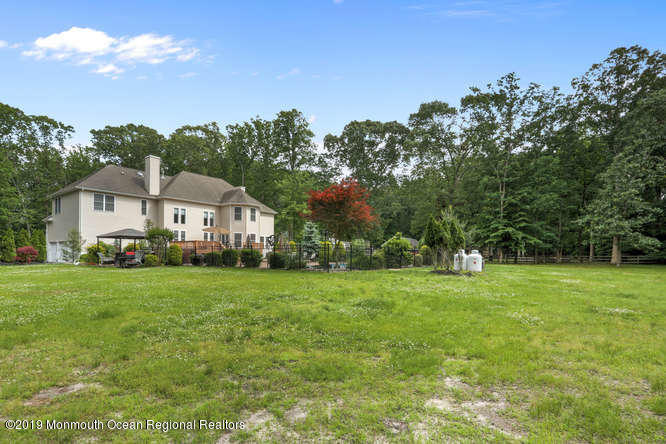 58 Fort Plains Road Howell, NJ 07731 - Photo 33 of 33 a front view of a house with a yard and trees